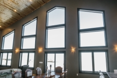 Large bay windows in a modern interior, showcasing natural light and a stylish design, part of The Window & Door Store's window replacement portfolio.