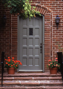 Brick home with dark grey steel front door.