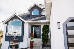 How Often Replace Windows Modern home entrance featuring stylish ProVia door, decorative planters, and energy-efficient windows, emphasizing curb appeal and window replacement importance.