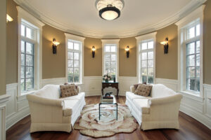 Rounded cream sitting room with elegant windows and sconces