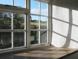 Close up of interior of old wood windows that show noticeable wear