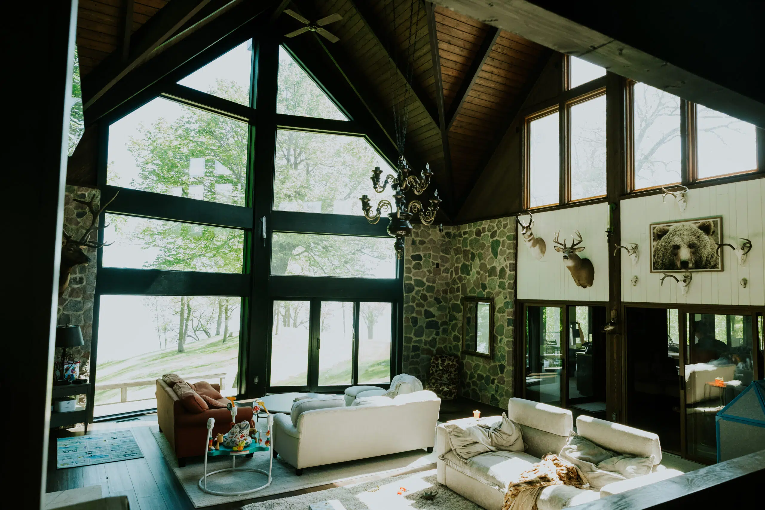 Modern living room with large windows and stone fireplace in Bismarck, ND home.